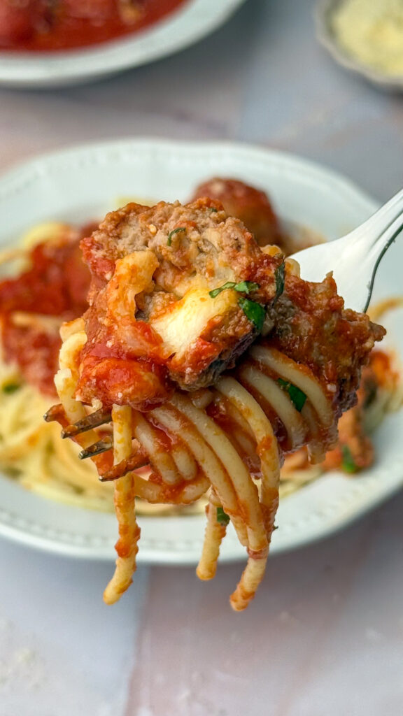 cheese stuffed meatball over spaghetti