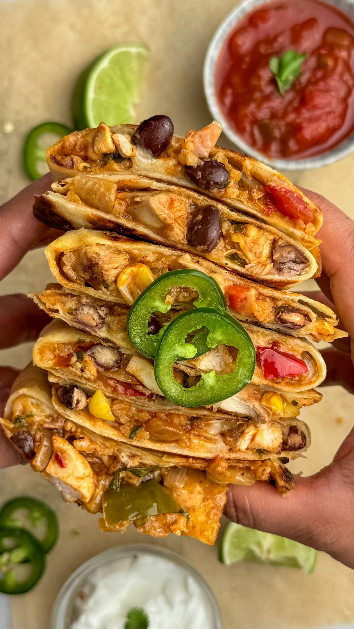 chicken bean and veggie quesadillas stacked on on top of the other cut side showing.