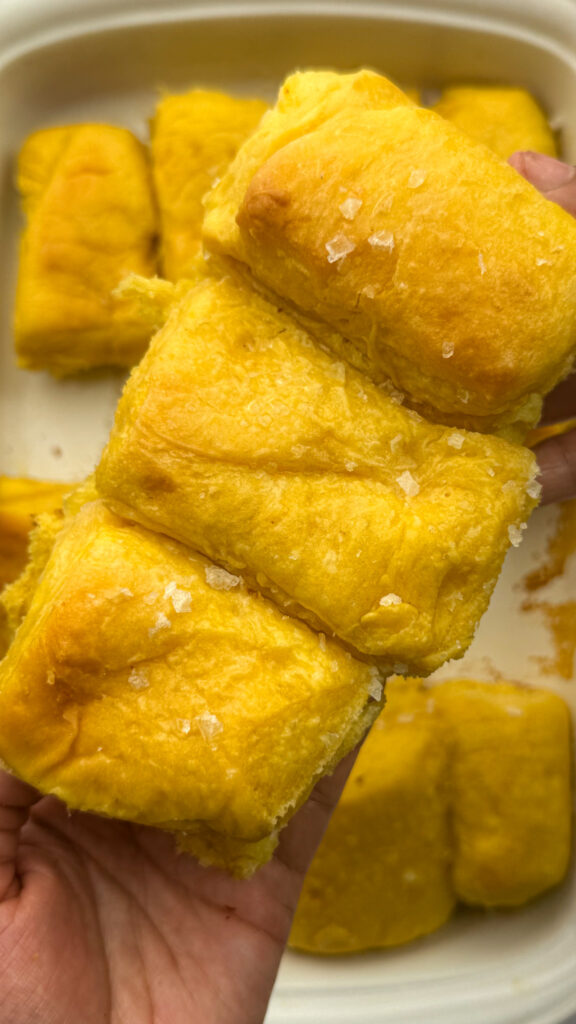 Sweet potato Parker house rolls, three together showcasing the top