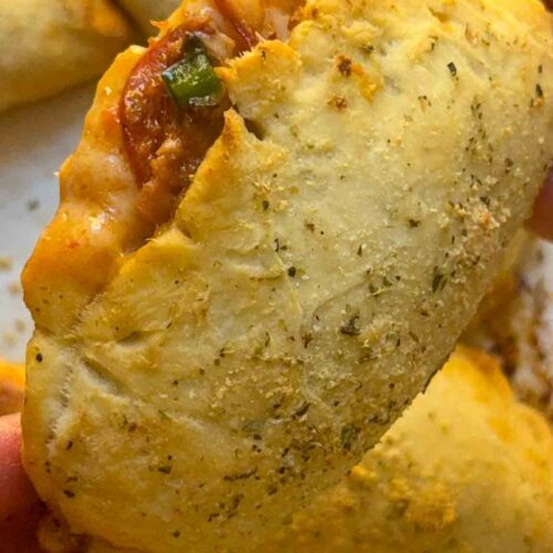 fluffy and soft pizza pocket, bursting open with cheese pepperoni and veggies
