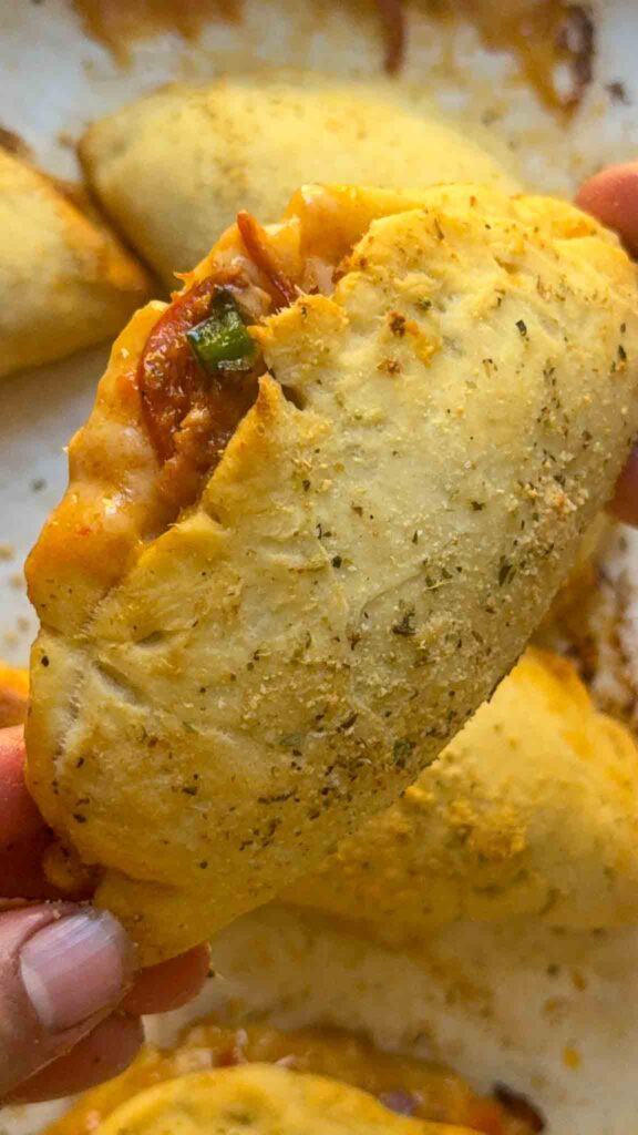 fluffy and soft pizza pocket, bursting open with cheese pepperoni and veggies